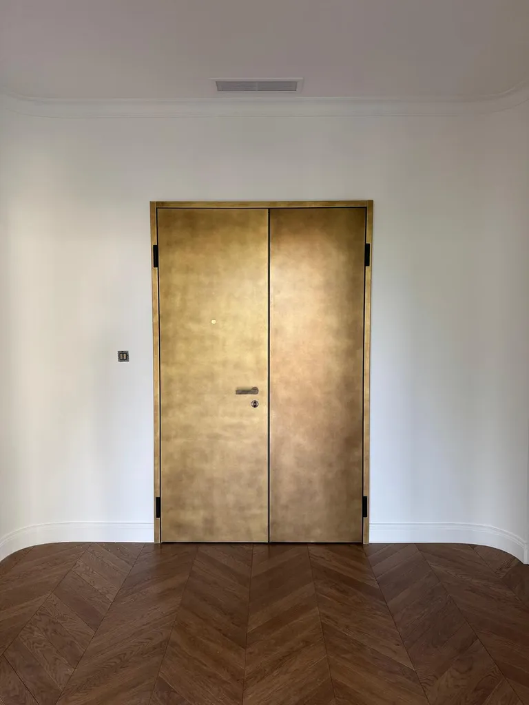 Une Silvelox Sikura double vantaux finition Metal Skin laiton doré au dernier étage du Vieil Ajaccio : quand une porte d'appartement devient une déclaration