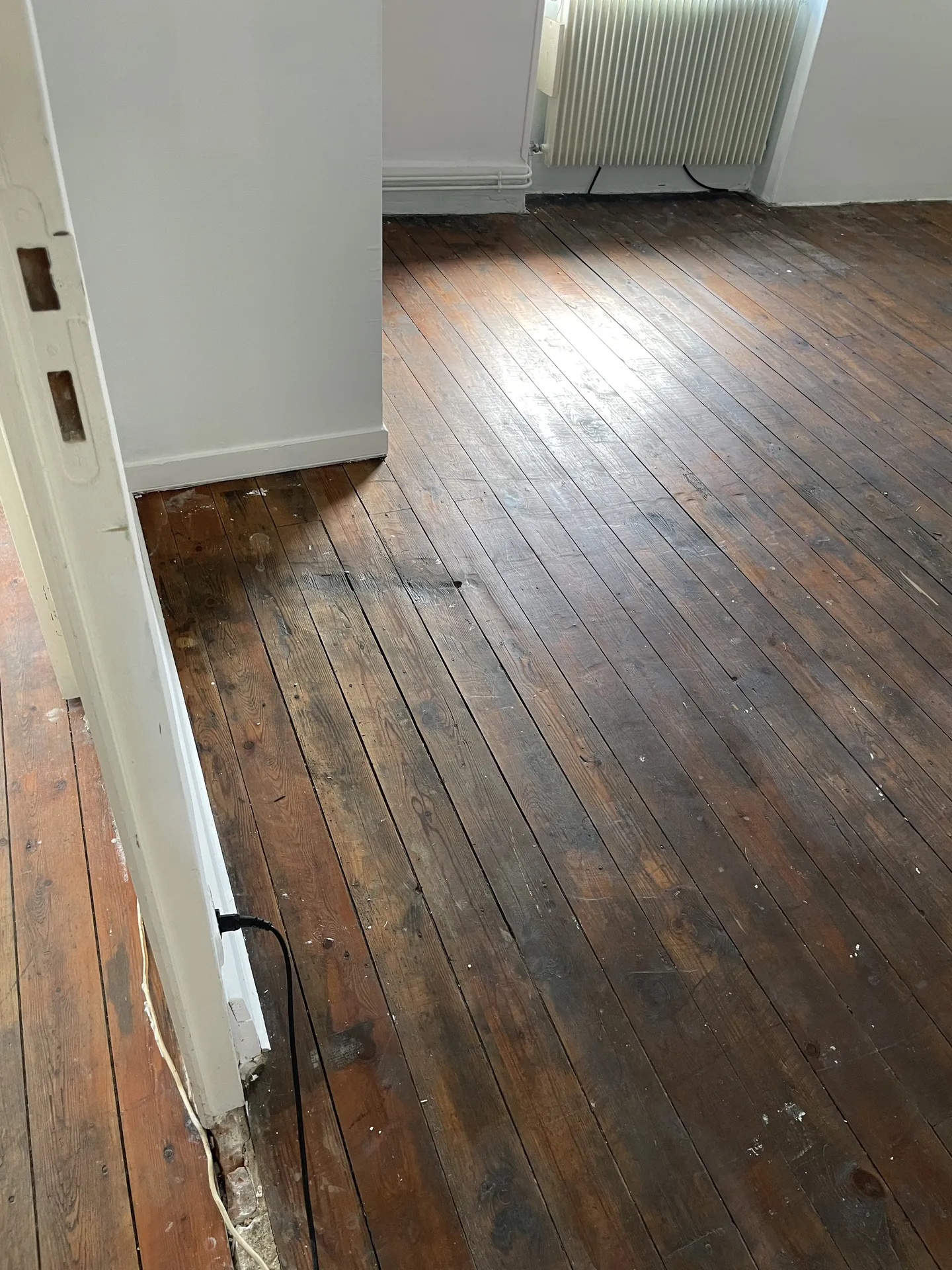 Parquet du salon avant rénovation avec usure visible, rayures et teinte ternie à Belleville-en-Beaujolais