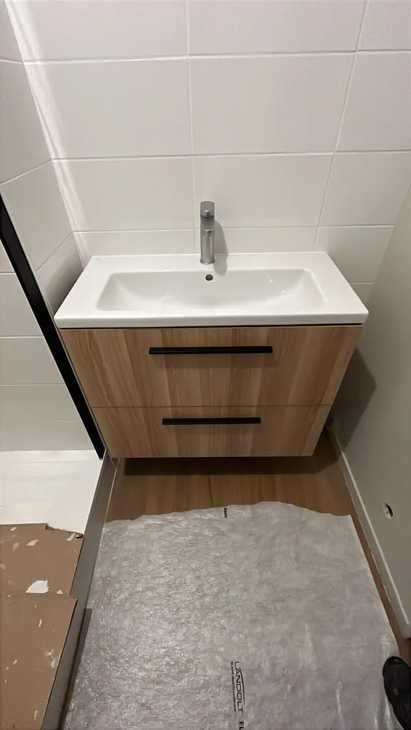 Plombier pour rénovation salle de douche Le Havre : remplacement meuble vasque et douche moderne avec porte coulissante