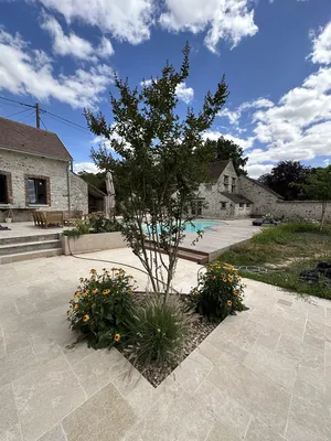 Rénovation des abords d’une piscine à Villemaréchal : terrasse bois, pierre du Sinaï et massifs paysagers