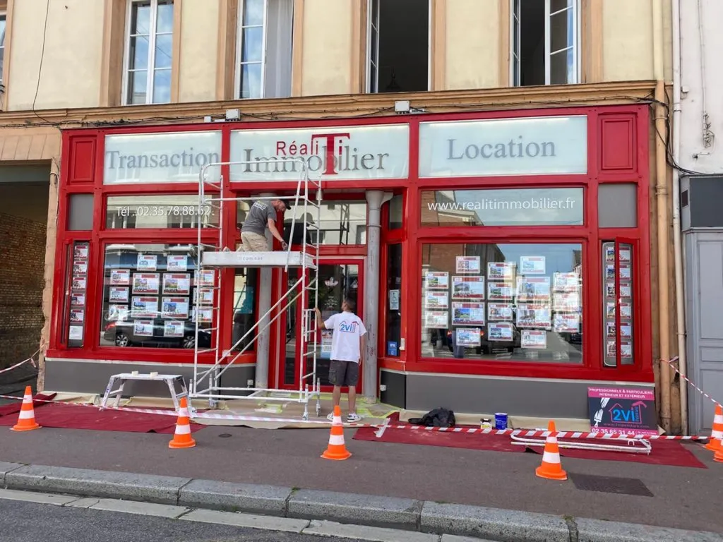 Rénovation peinture d'une facade commerciale en bois avec poteaux béton à ELBEUF 