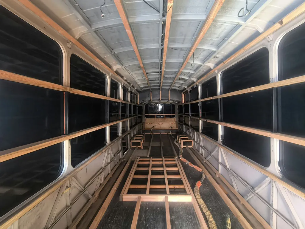 Isolation thermique et phonique d'un bus aménagé par projection de mousse polyuréthane à cellules fermées.