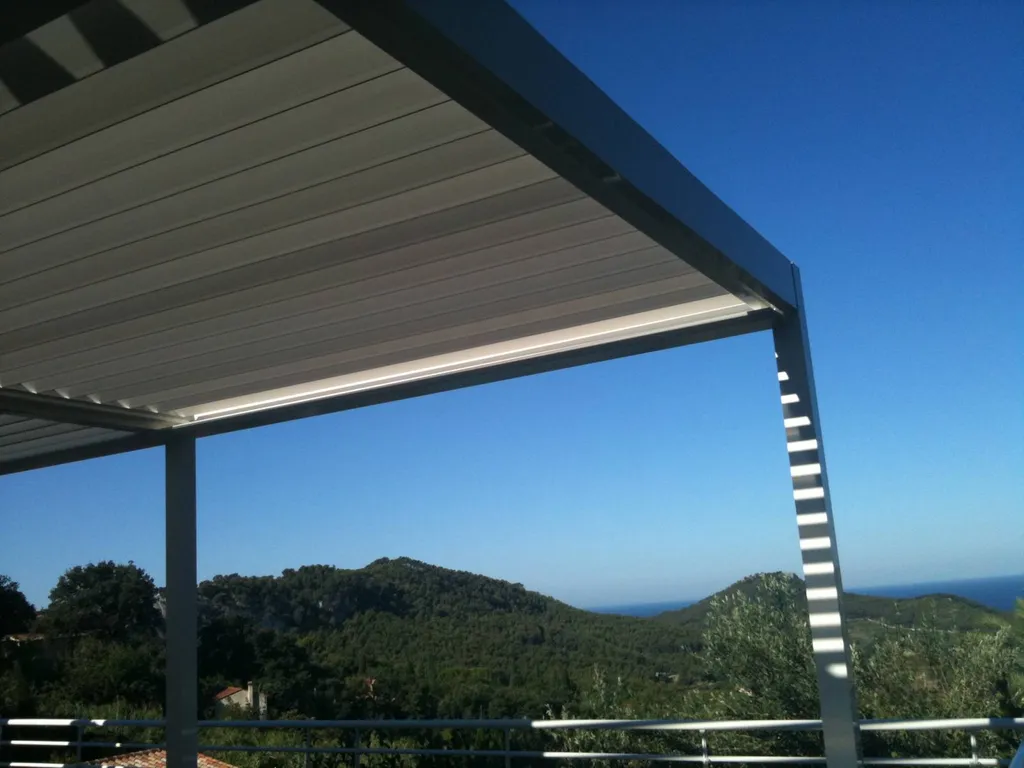 Installation d'une pergolas bioclimatique blanche en aluminium pour couvrir une terrasse face à la mer à Bandol