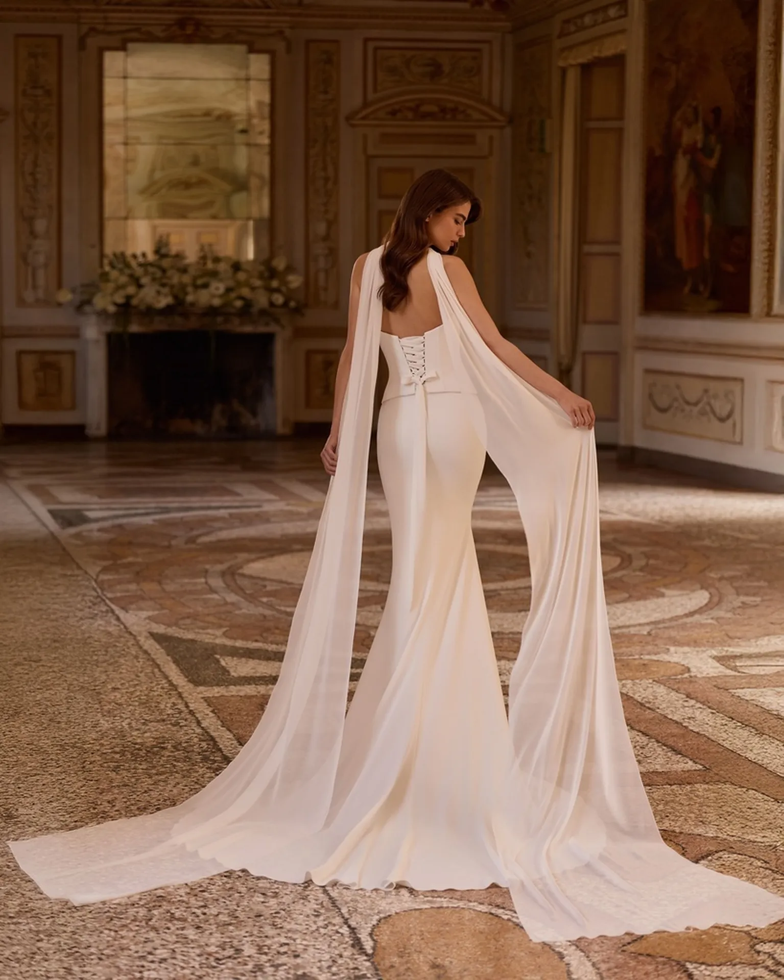 Robe de mariée sirène ALYSUM d'Alberto Palatchi avec sa cape amovible drapée dans le dos, silhouette en crêpe ivoire