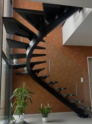 Escalier limon central cintré débillardé avec marches en chêne massif et garde corps vitré à Tassin-la-Demi-Lune dans l'ouest lyonnais