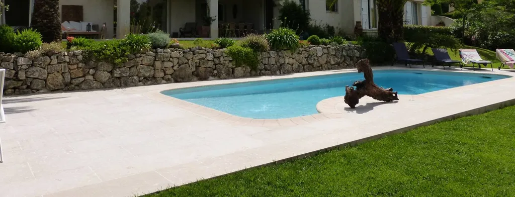 dallage pierre d'egypte autour d'une piscine devant une maison à Grasse, Antibes, Nice