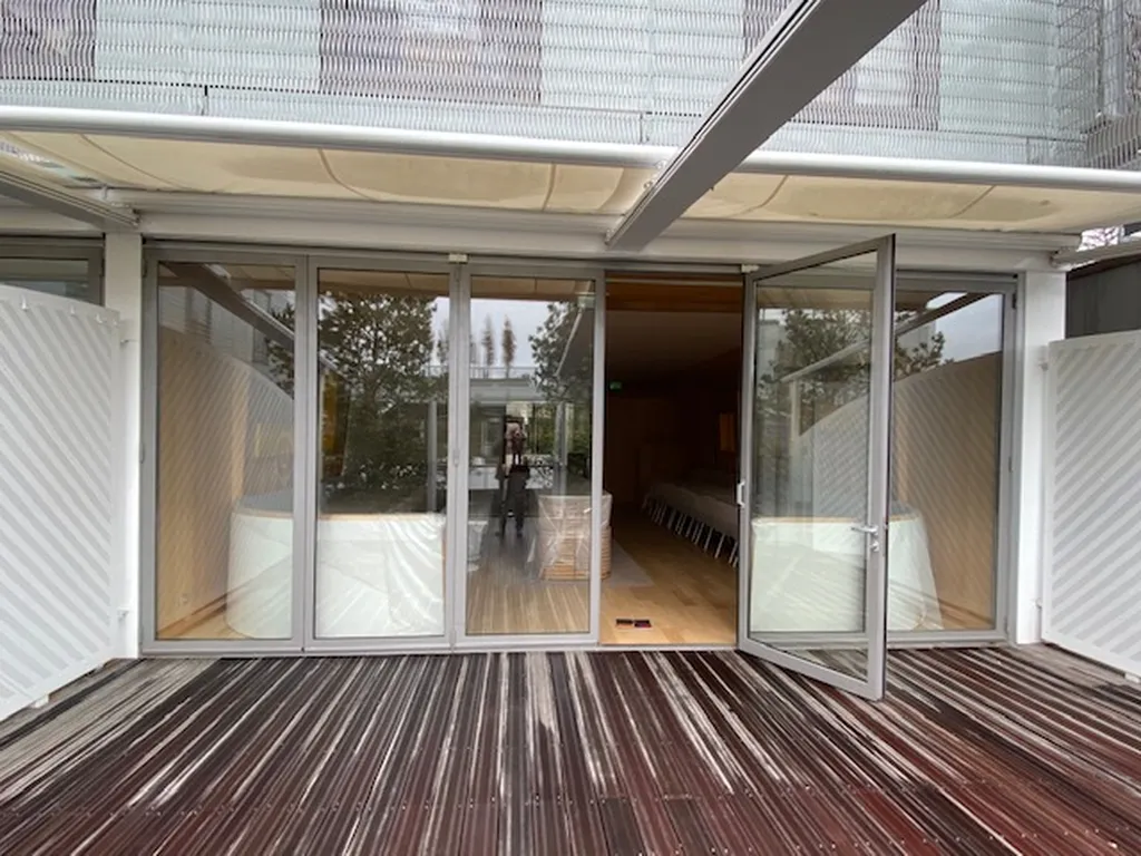 Création d’une porte d’entrée repliable en aluminium gris anodisé à Roland Garros à Paris