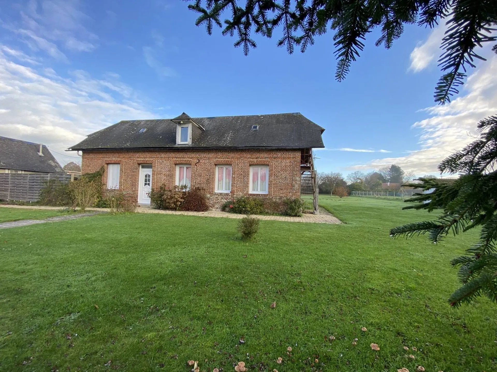 Une longère offrant de plain pied : un séjour salle à manger, cuisine aménagée, une salle d'eau, 2 chambres.