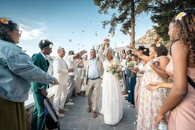 Un mariage civil organisé sur le parvis d'une chapelle blanche les pieds dans l'eau à Rhodes en Grèce