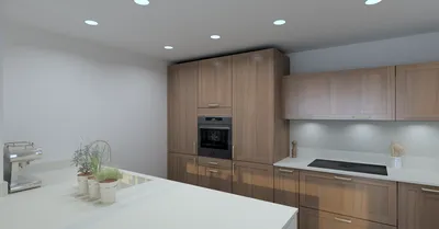 Cuisine sur mesure bi-matières La Teste De Buch : façade à cadre en finition noyer associé à du blanc soyeux sur la presqu'île : poignées en laiton.