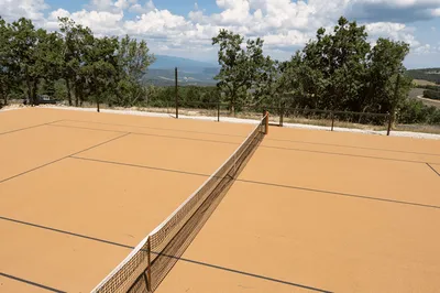 Experience a premium tennis court in Provence offering panoramic mountain views and a serene natural setting for unforgettable matches