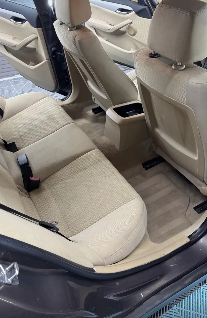 Nettoyage en profondeur des tissus blanc de siège arrière d'une voiture Renault Megane pour rattraper la couleur et redonner une nouvelle jeunesse à Genève en Suisse