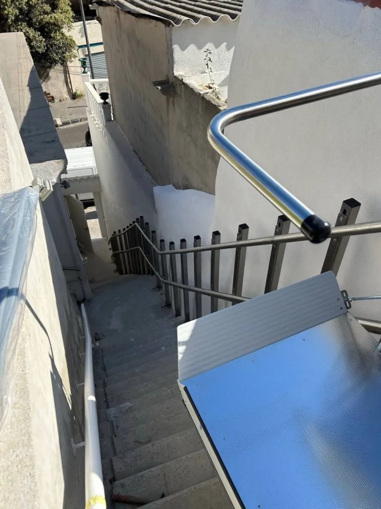 Vue depuis l'arrivée de la plateforme oblique Lehner Stratos en extérieur dans un escalier droit avec palier intermédiaire à proximité de la mer à Marseille