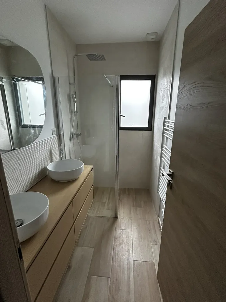 Salle de bain rénovée après dégât des eaux à Lachassagne avec carrelage moderne et finitions soignées