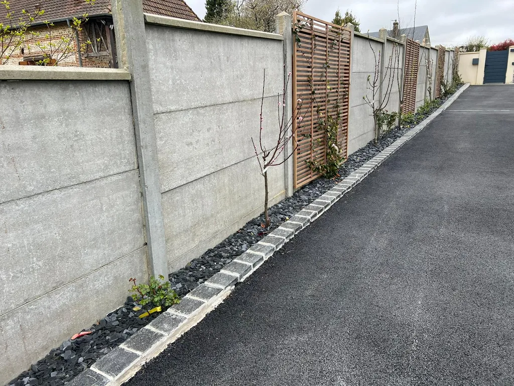 Massif avec paillis d'ardoise pour embellir le mur