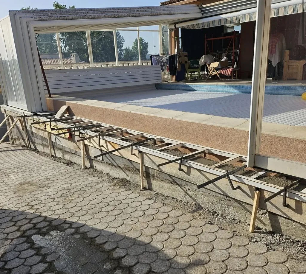 Sécurisation complète d'une véranda affaissée avec mur en béton armée et renforcement durable des fondations extérieurs existantes