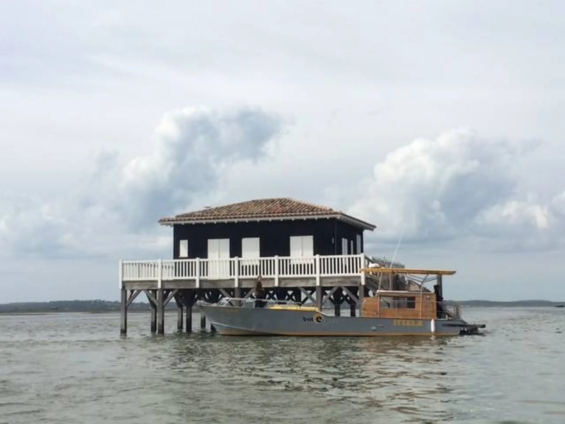 Bateau type Vedette chaland ostréicole devant une cabane tchanquée