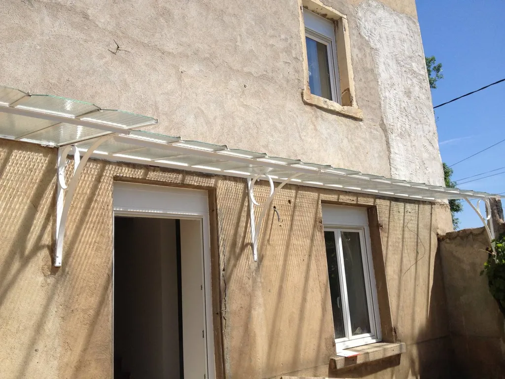 réfection avec du vitrage en verre armé sur Marquise