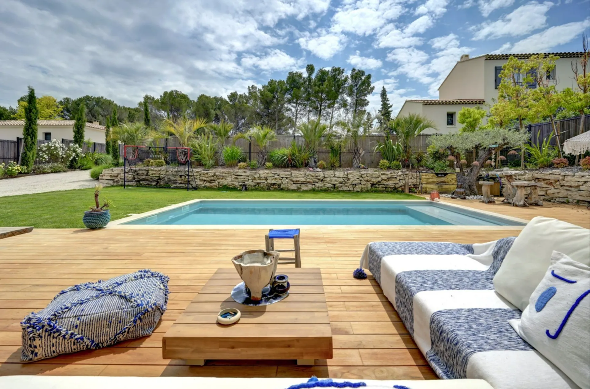 Terrasse bois donnant sur une piscine intégrée dans une villa contemporaine
