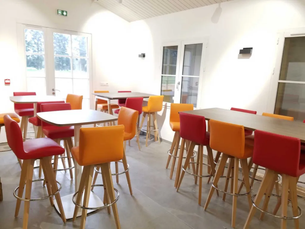Réhabilitation de 200 m² de bureaux à Cheval-Blanc avec table de réunion 20 places, cafétéria colorée et design bois/blanc chaleureux
