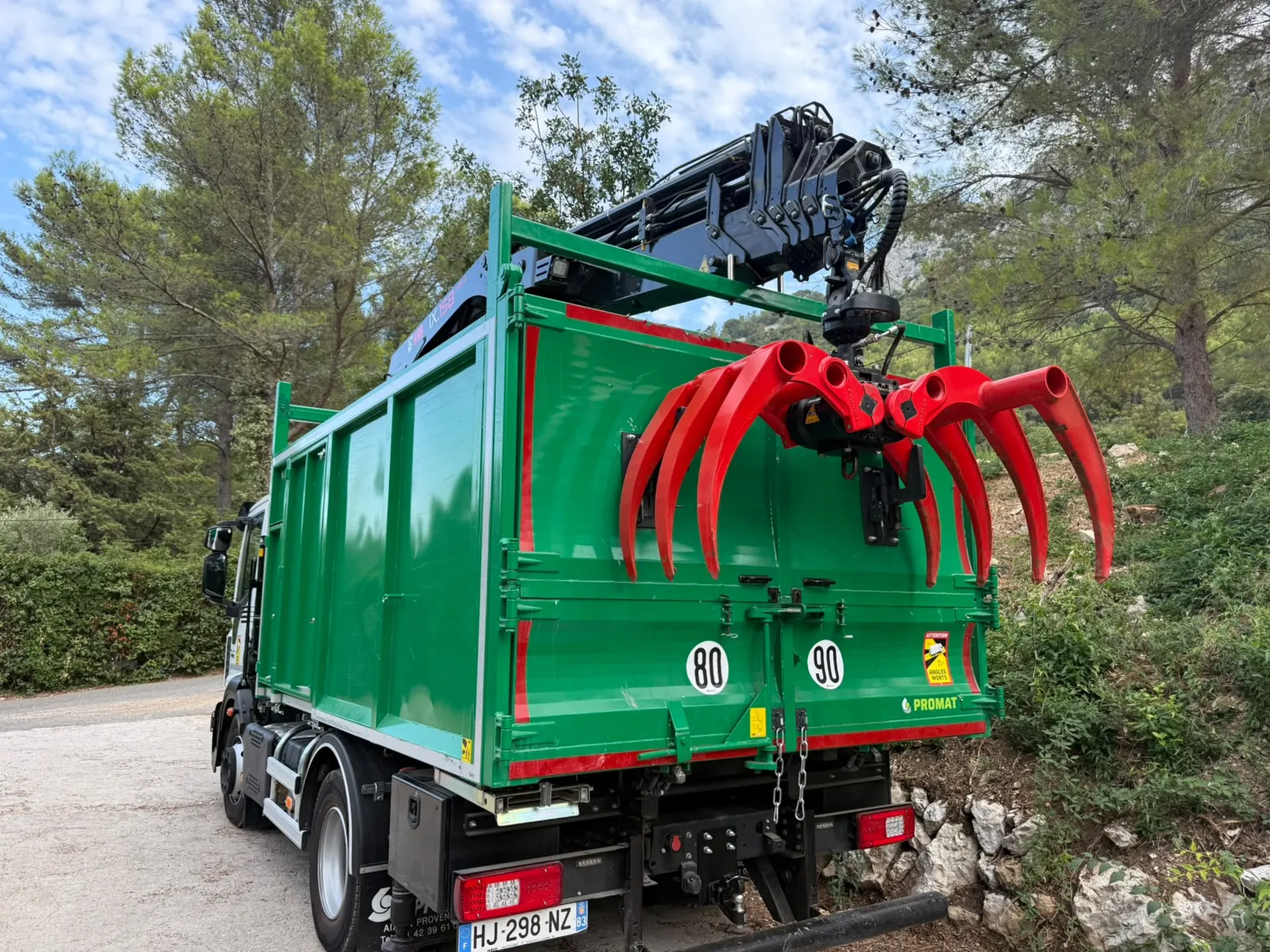 Camion-grue Jardivar équipé d'un grappin hydraulique, conçu pour faciliter la manutention et l'évacuation du bois et des branches sur les chantiers d'élagage et d'abattage.