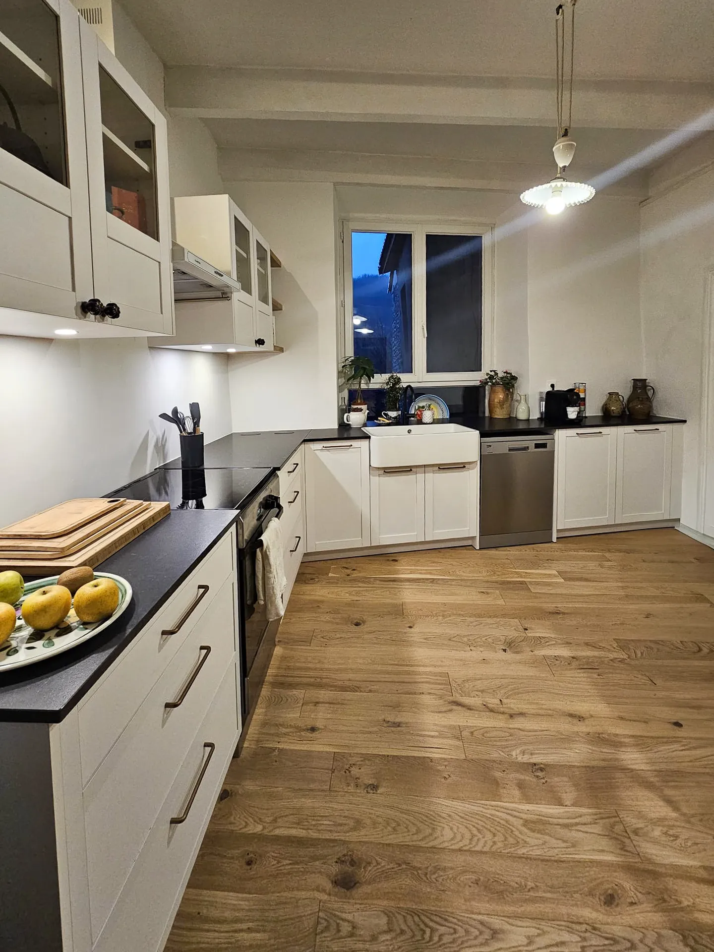 Cuisine sur mesure blanche et chêne à Vogüé : agencement en L, évier timbre d’office et finitions soignées