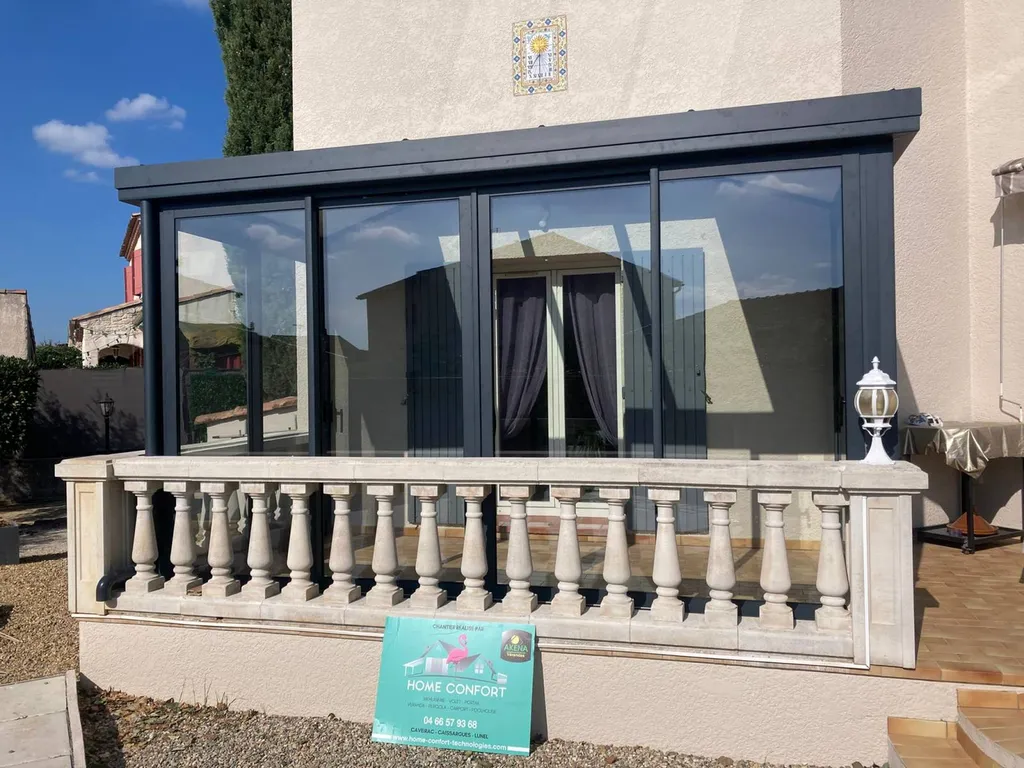 Installation d'une véranda intégrée sur une terrasse dans une maison de village sur la commune de Milhaud