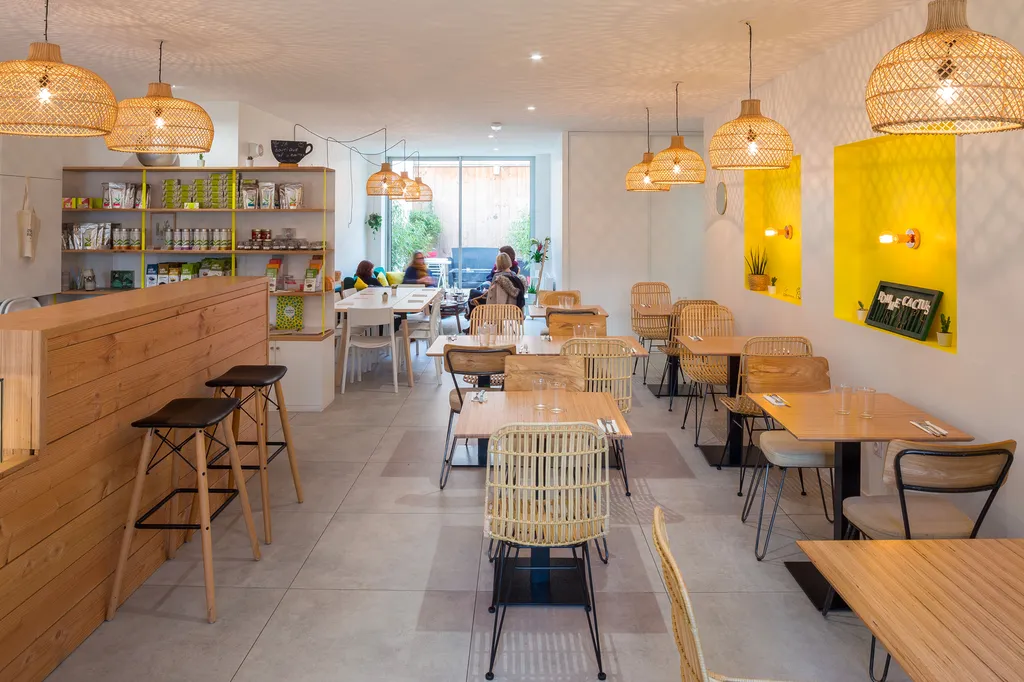 AKIKO ARCHITECTURE – Blanquefort / Taillan-Médoc – Rénovation & réagencement L’agence a conçu un espace traversant où la lumière circule librement, mettant en valeur les assises en bois et cannage. Au fond, l’ouverture sur la petite cour crée un prolongem