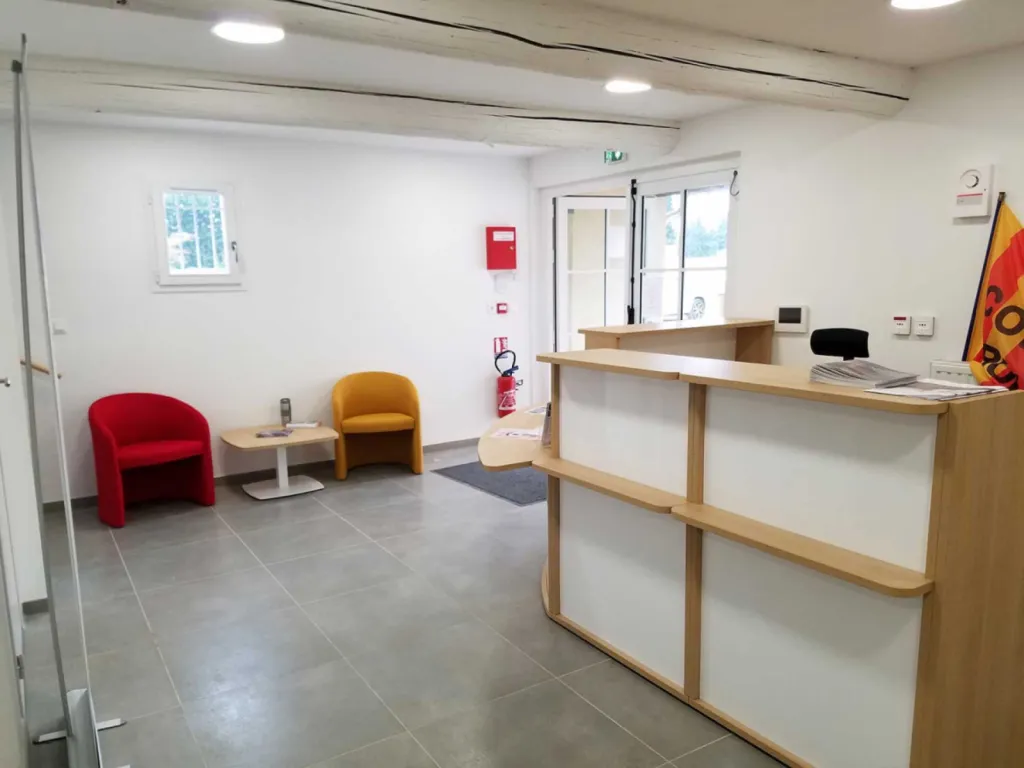 Réhabilitation de 200 m² de bureaux à Cheval-Blanc avec table de réunion 20 places, cafétéria colorée et design bois/blanc chaleureux