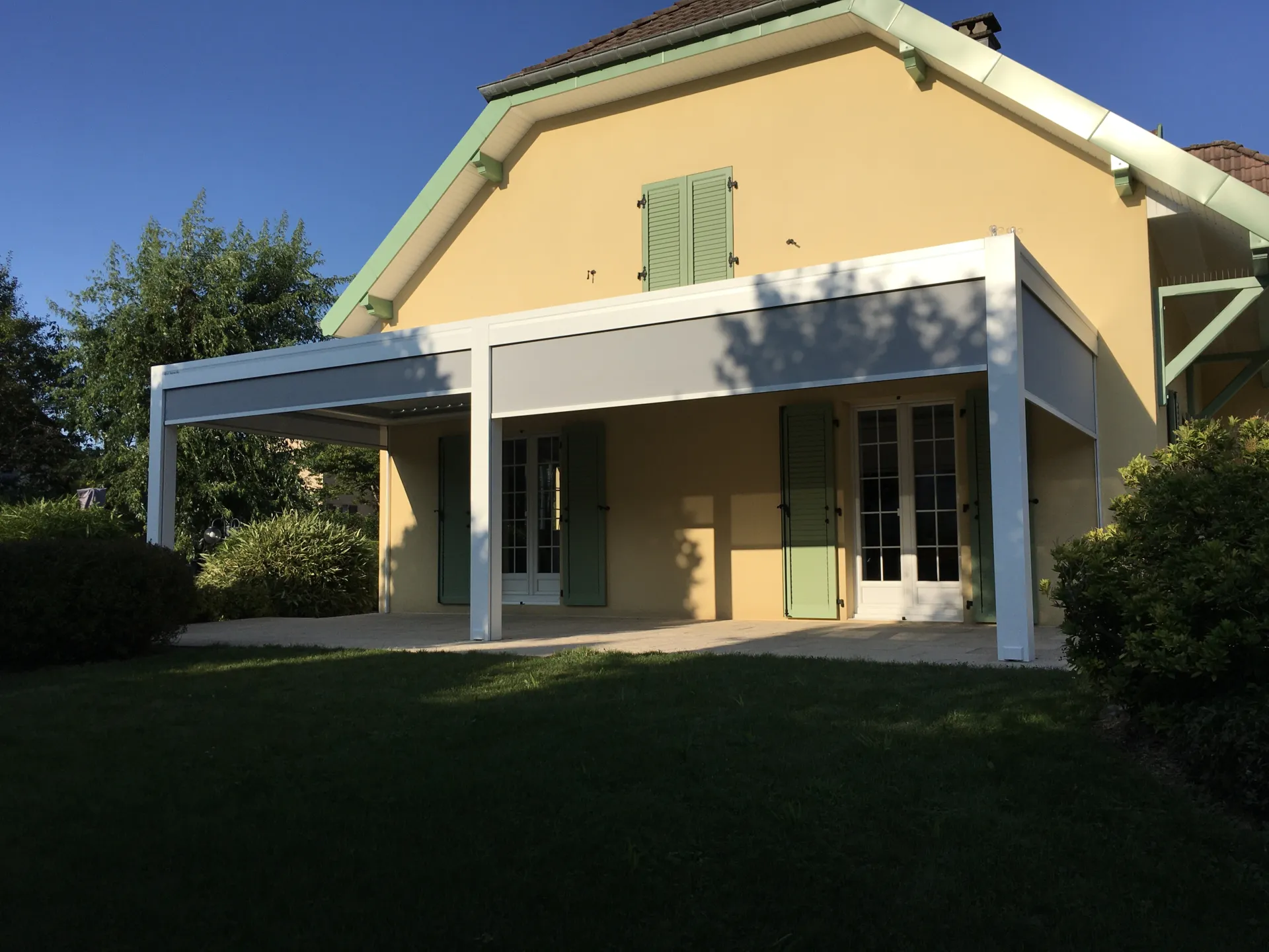 Réalisation d’une pergola bioclimatique aluminium double module laqué teinte blanc sablé attenante à Bermont près de Belfort