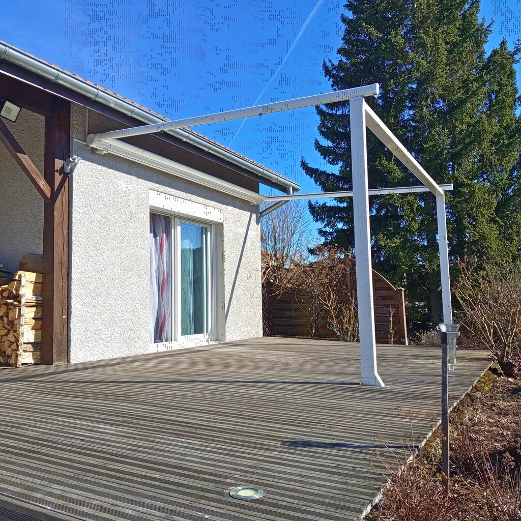 Installation d'une pergola en aluminium avec toile enroulable avec coffre sur terrasse en bois à Yssingeaux en Haute-Loire par 3 Baies