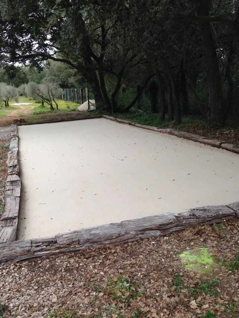 Réalisation d'un terrain de pétanque dans un jardin à Grans