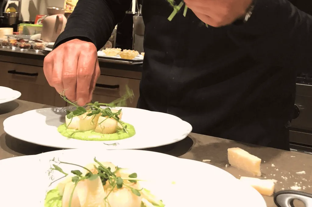 The private chef of Domaine Château du Bois dressing up the plates for an authentic Provençal meal at the Table d'Hôtes