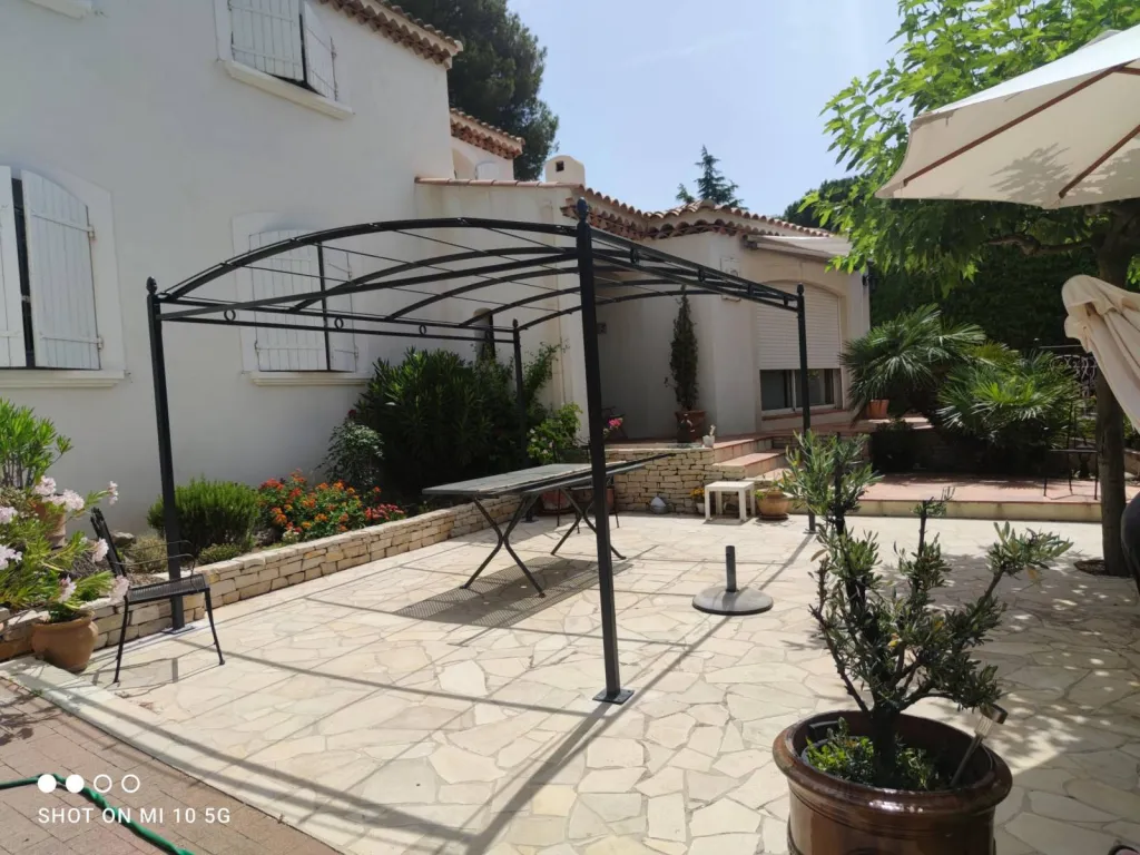 PERGOLA AUTOPORTANTE POUR TERRASSE FABRIQUEE SUR MESURE DECORATIONS FER FORGE PIGNES DE PINS ET CERCLES DANS LES BOUCHES DU RHONE A MARTIGUES