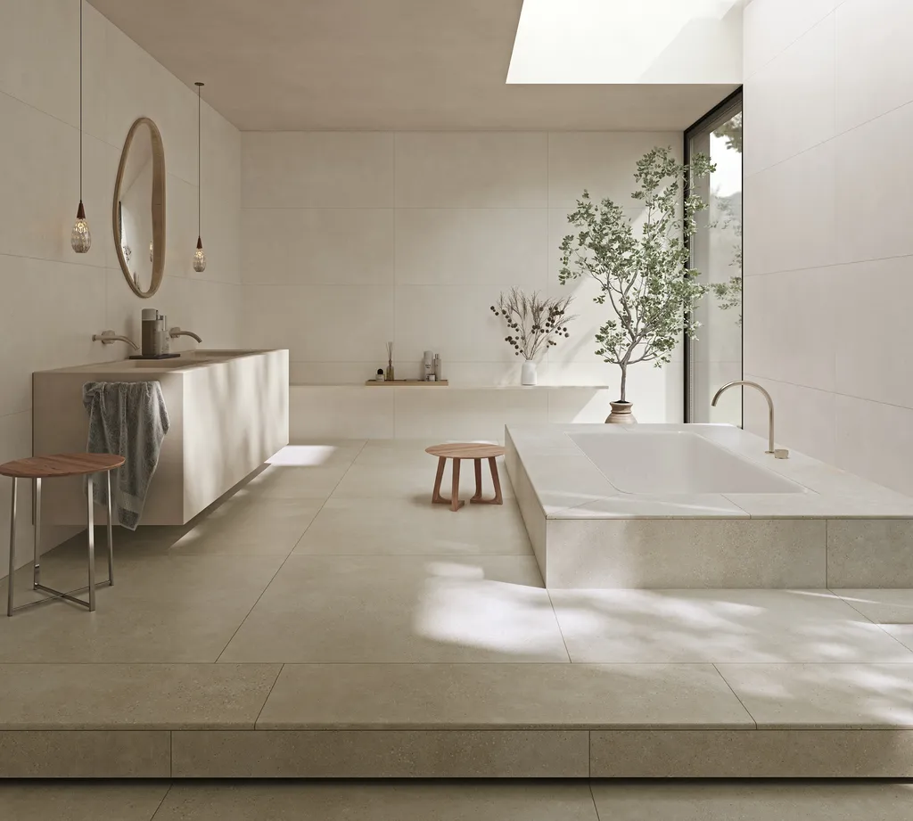 Vaste salle de bain contemporaine avec sol murs et baignoire en carrelage terrazzo salle de bain Vida teinte Arena La Ciotat