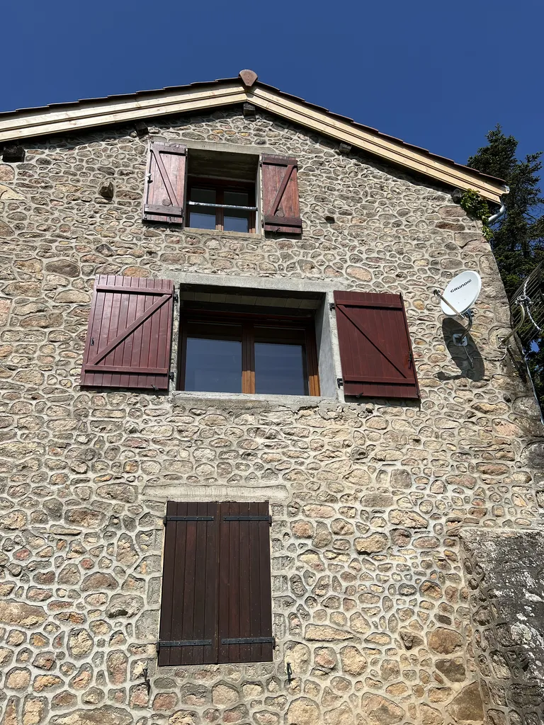 Façade après agrandissement de fenêtre dans une maison en pierre à Beaujeu (Rhône 69) améliorant l’esthétique et la luminosité