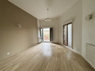  un séjour salon avec parquet au sol, porte fenêtre, ouvrant sur l'extérieur et Laforet