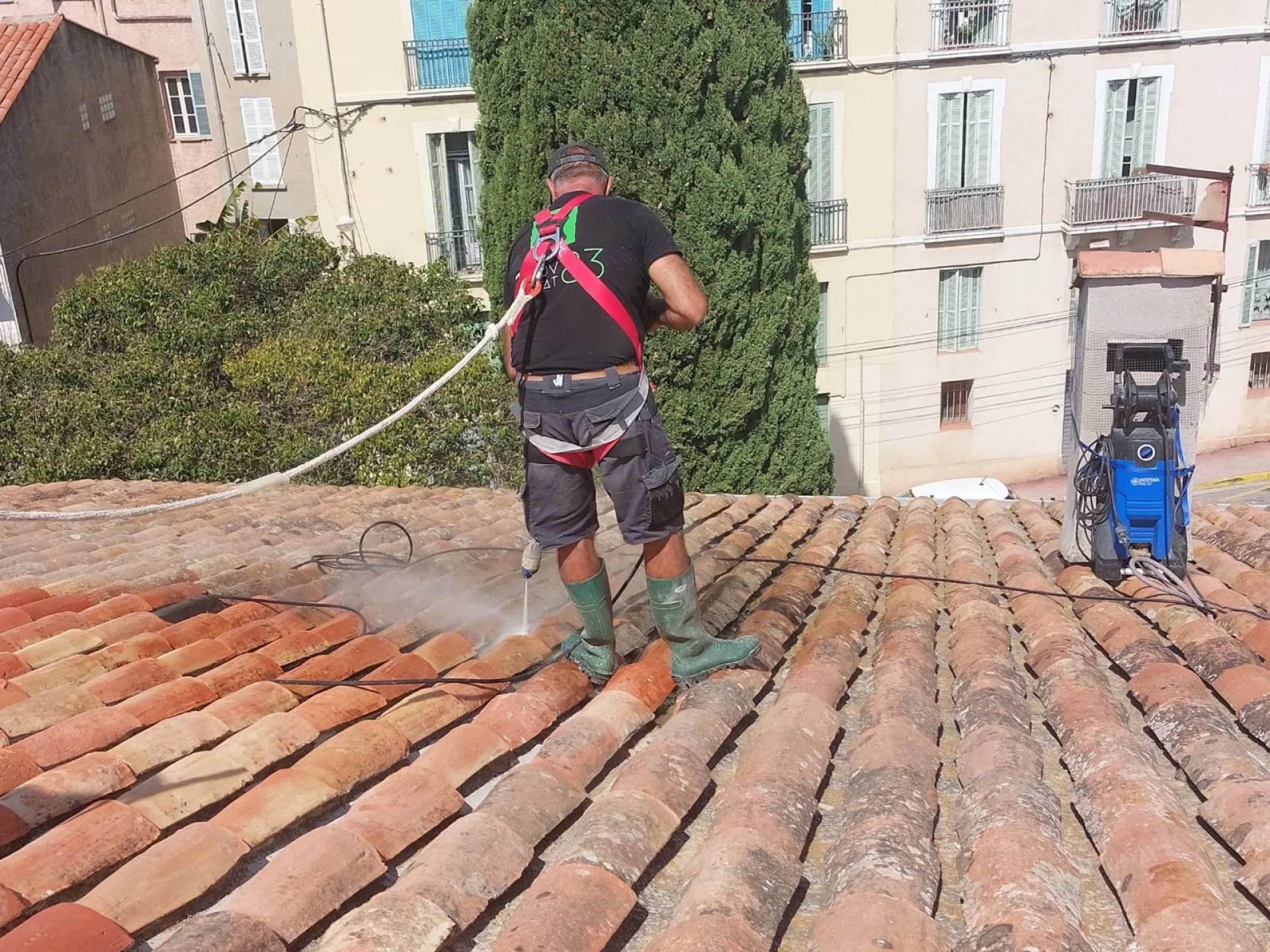 Entreprise du bâtiment nettoyant le toit d'une maison à Saint-Tropez dans le Var